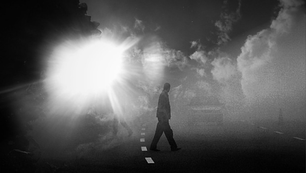 Mann im Nebel auf Straße, schwarzweiß